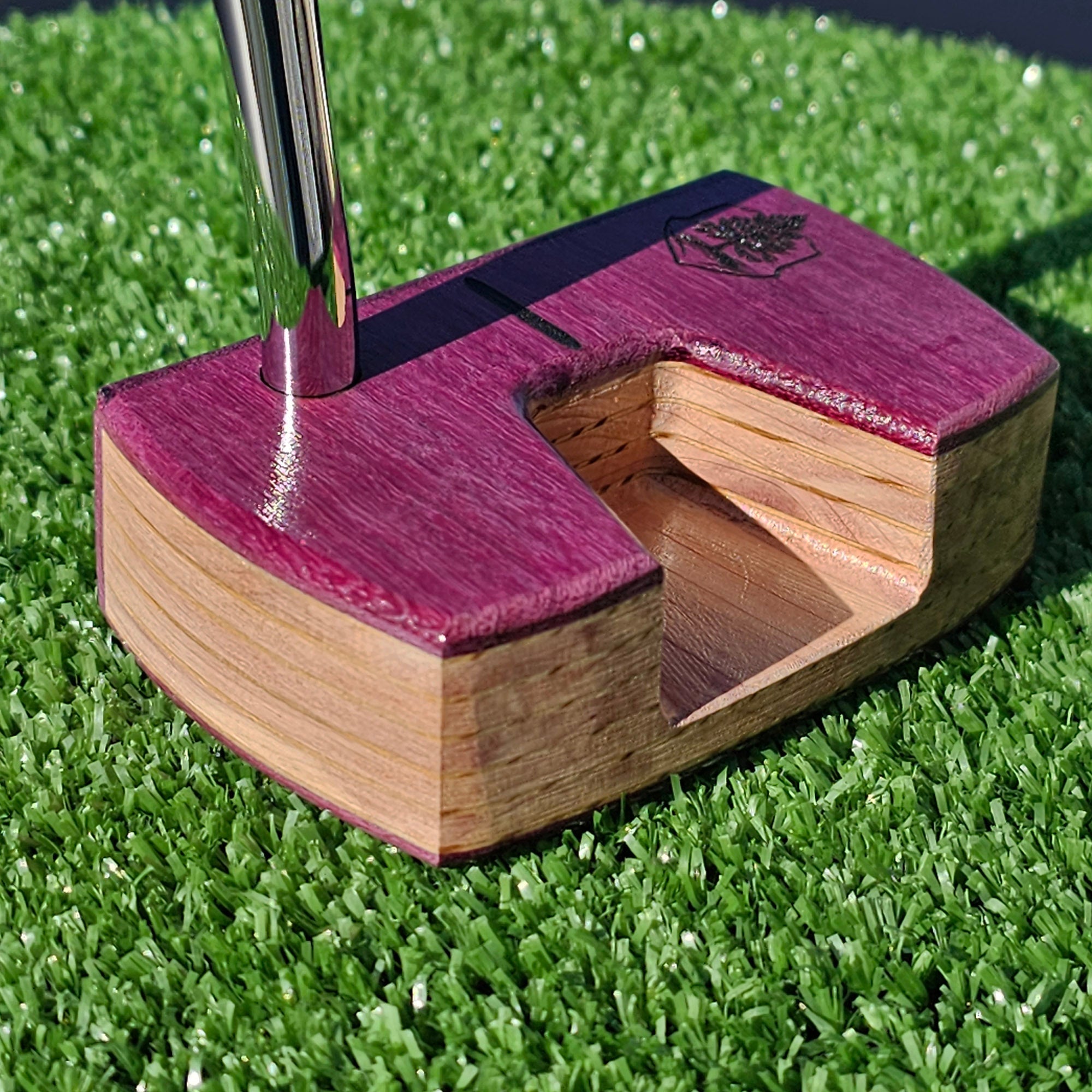 Golfer reading the slope of a green before a putt