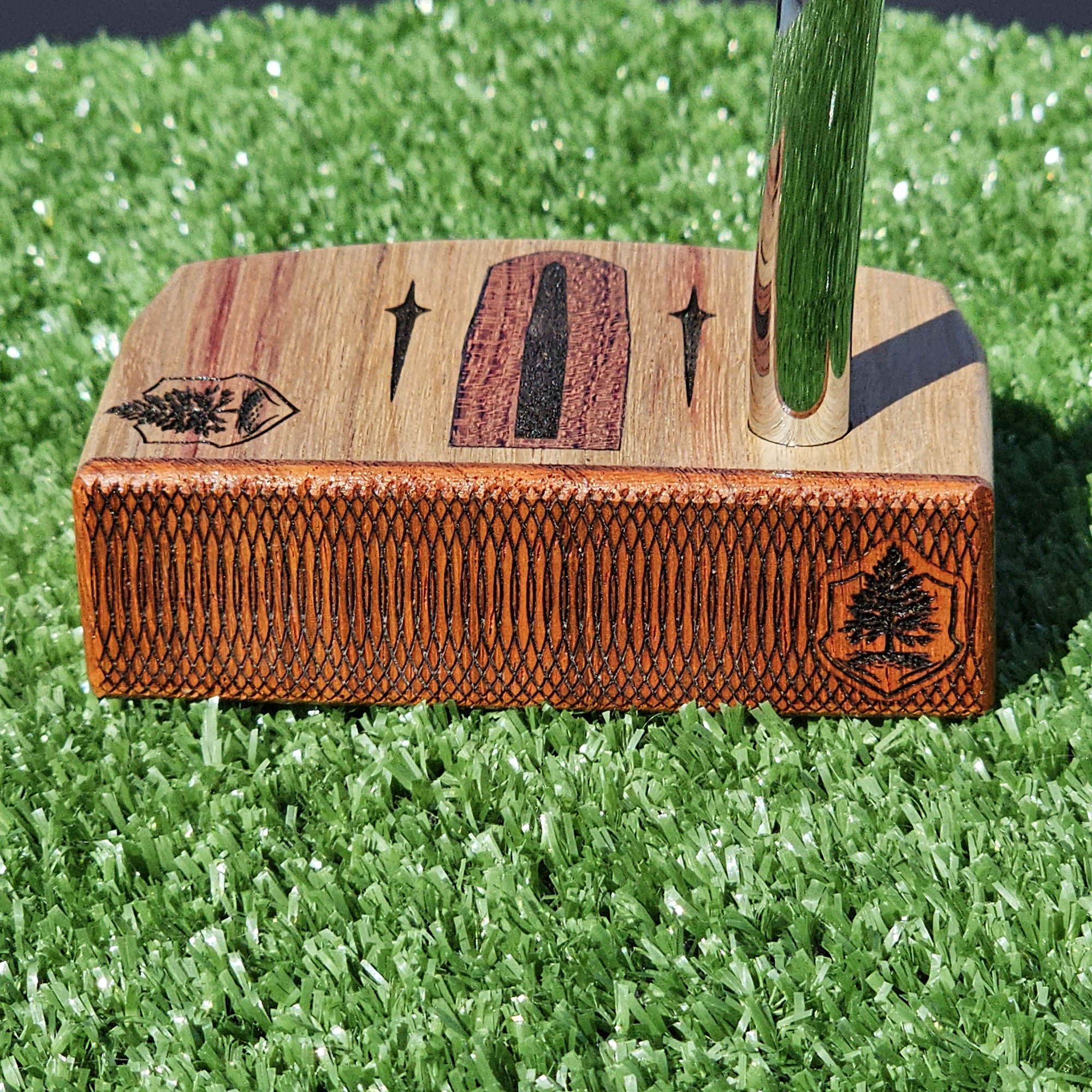 Golfer repairing a ball mark on a putting green