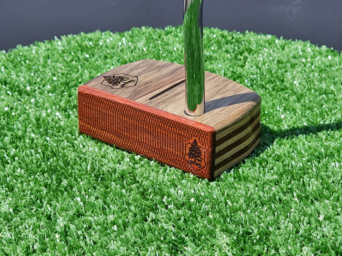 Golfer marking a golf ball on the putting green