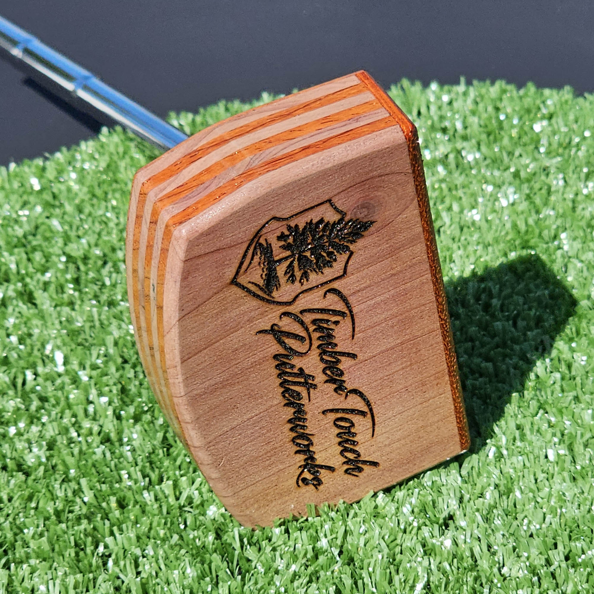 Layered Bloodwood and Red Cedar putter with decorative inlay