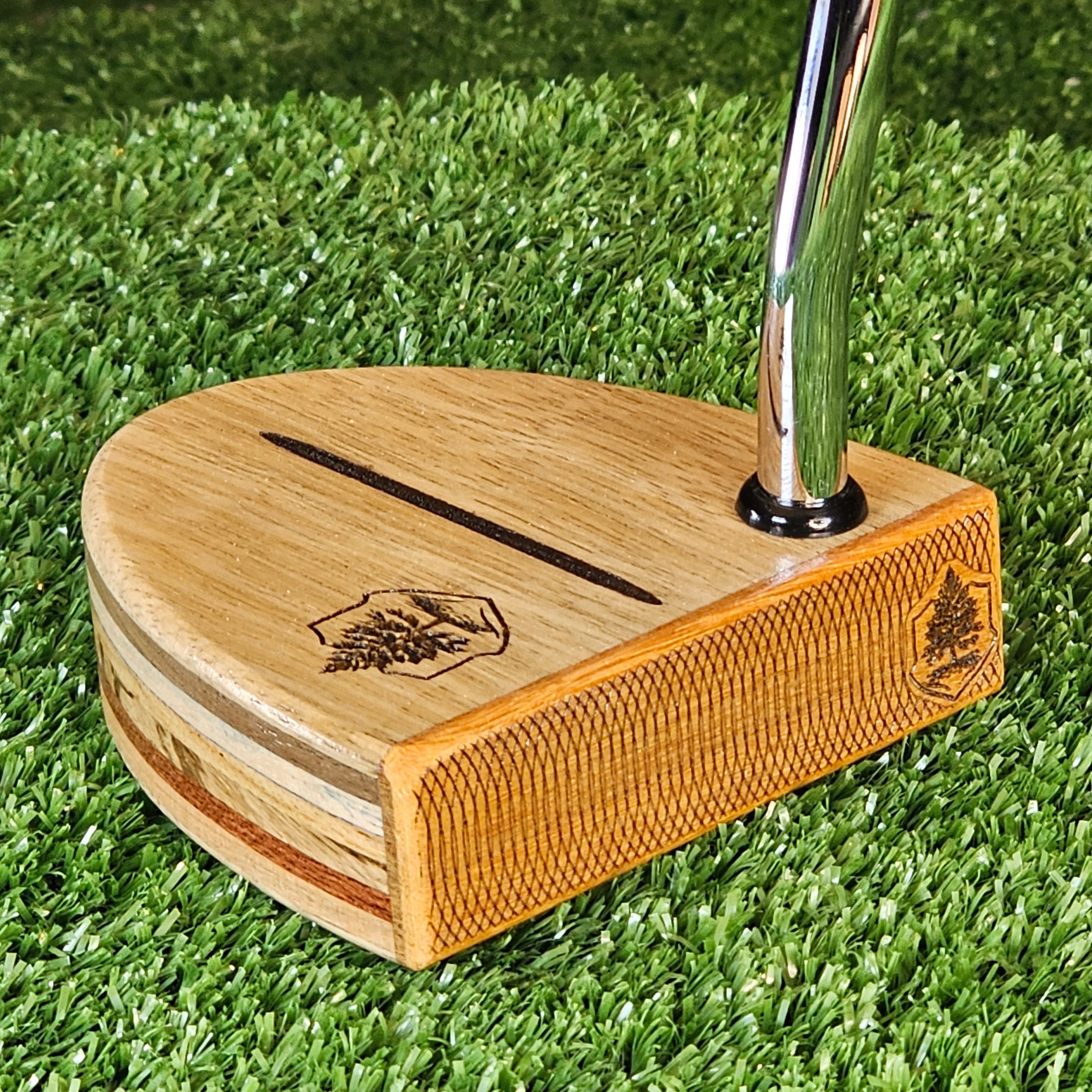 Black Limba exotic wood putter with various body plies and Osage Orange face