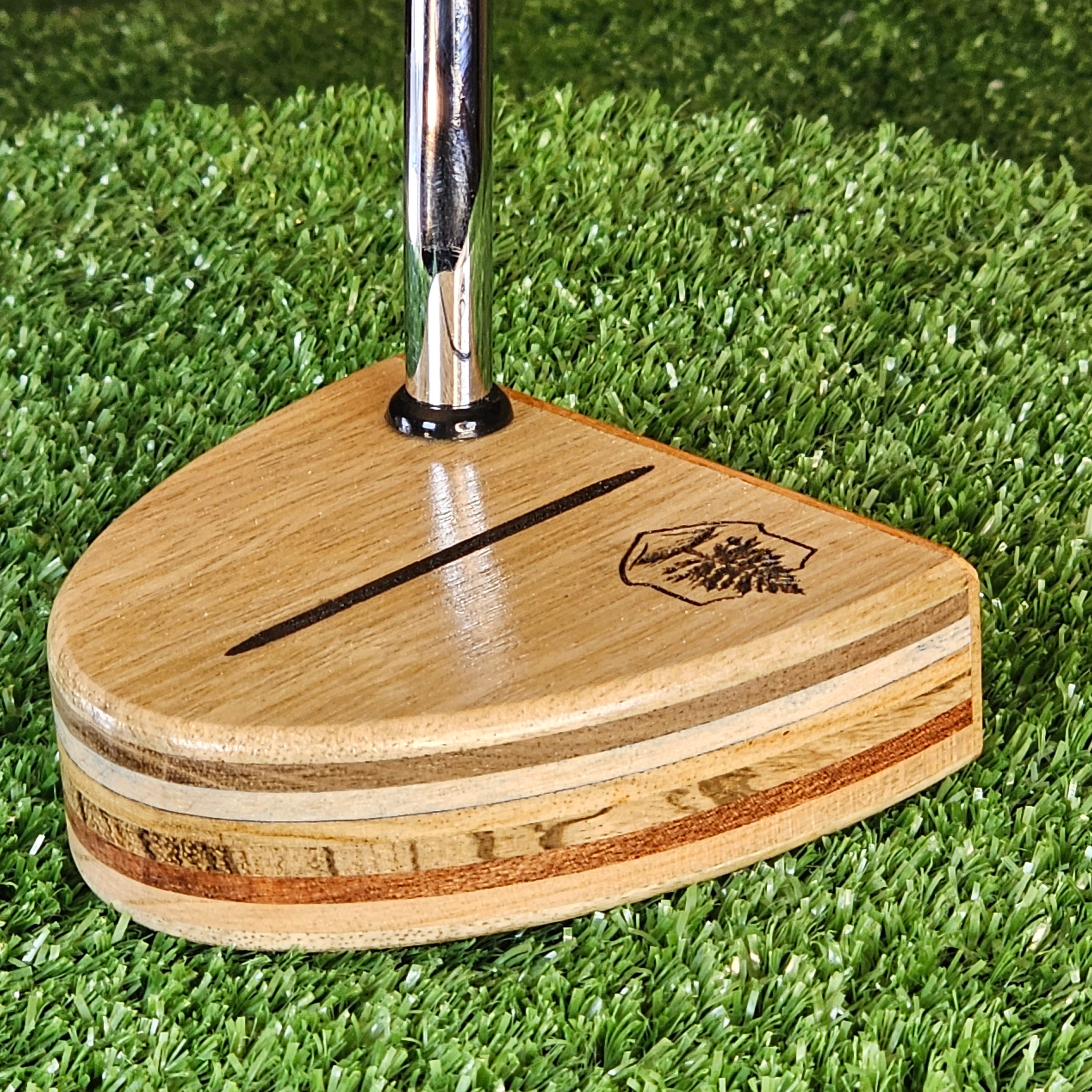 Black Limba exotic wood putter with various body plies and Osage Orange face