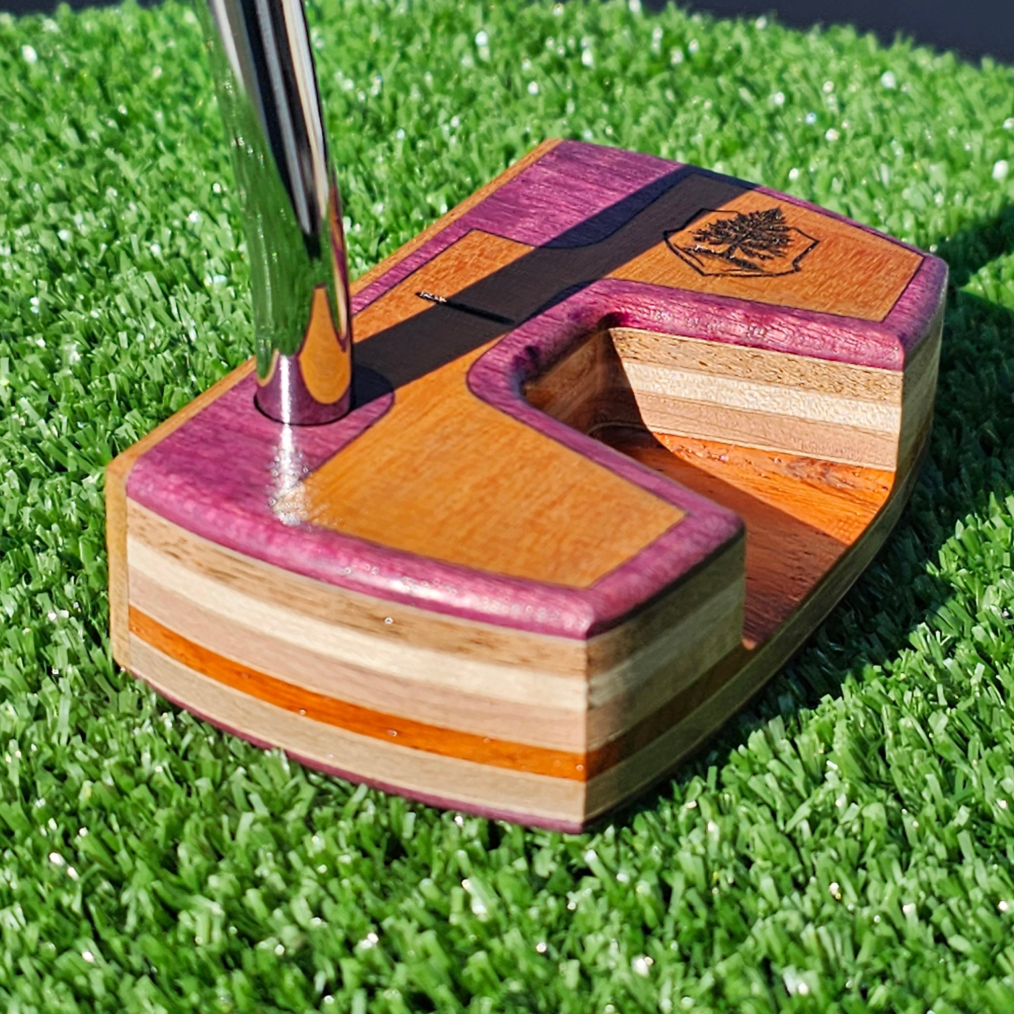 TimberTouch exotic wood putter at address on the putting green