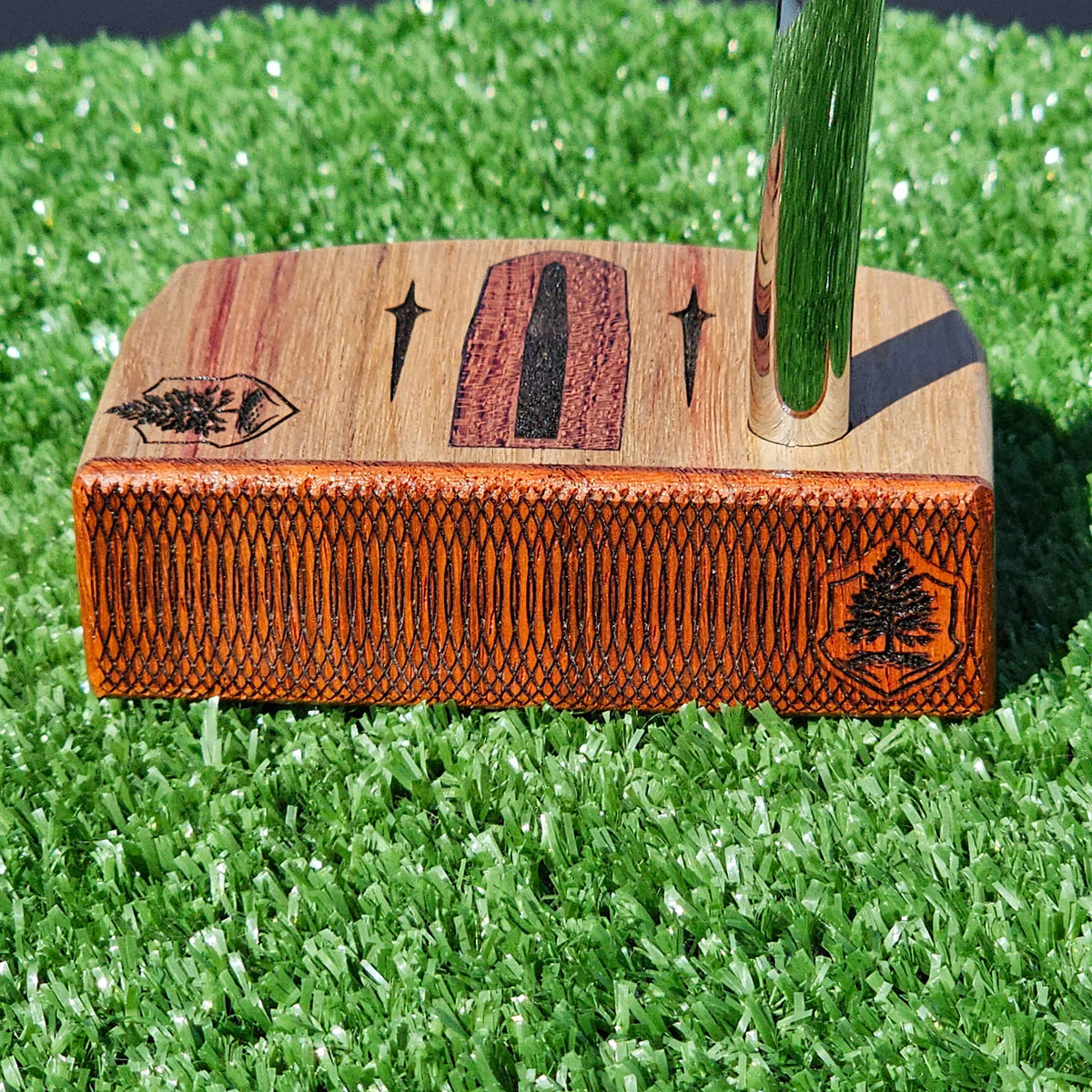 Golfer repairing a ball mark on a putting green