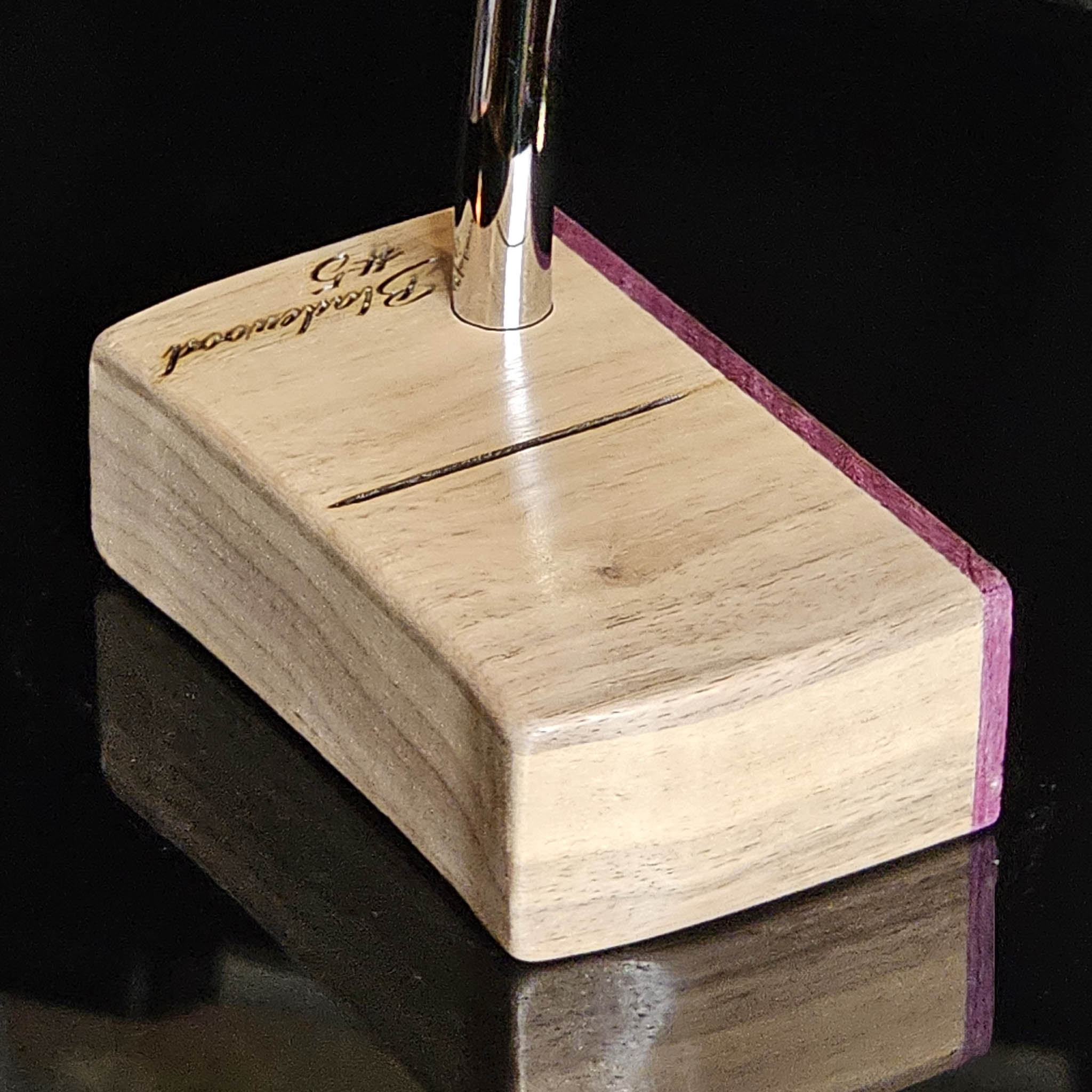 Walnut wood body putter with Purpleheart face.   Clean alignment line top view