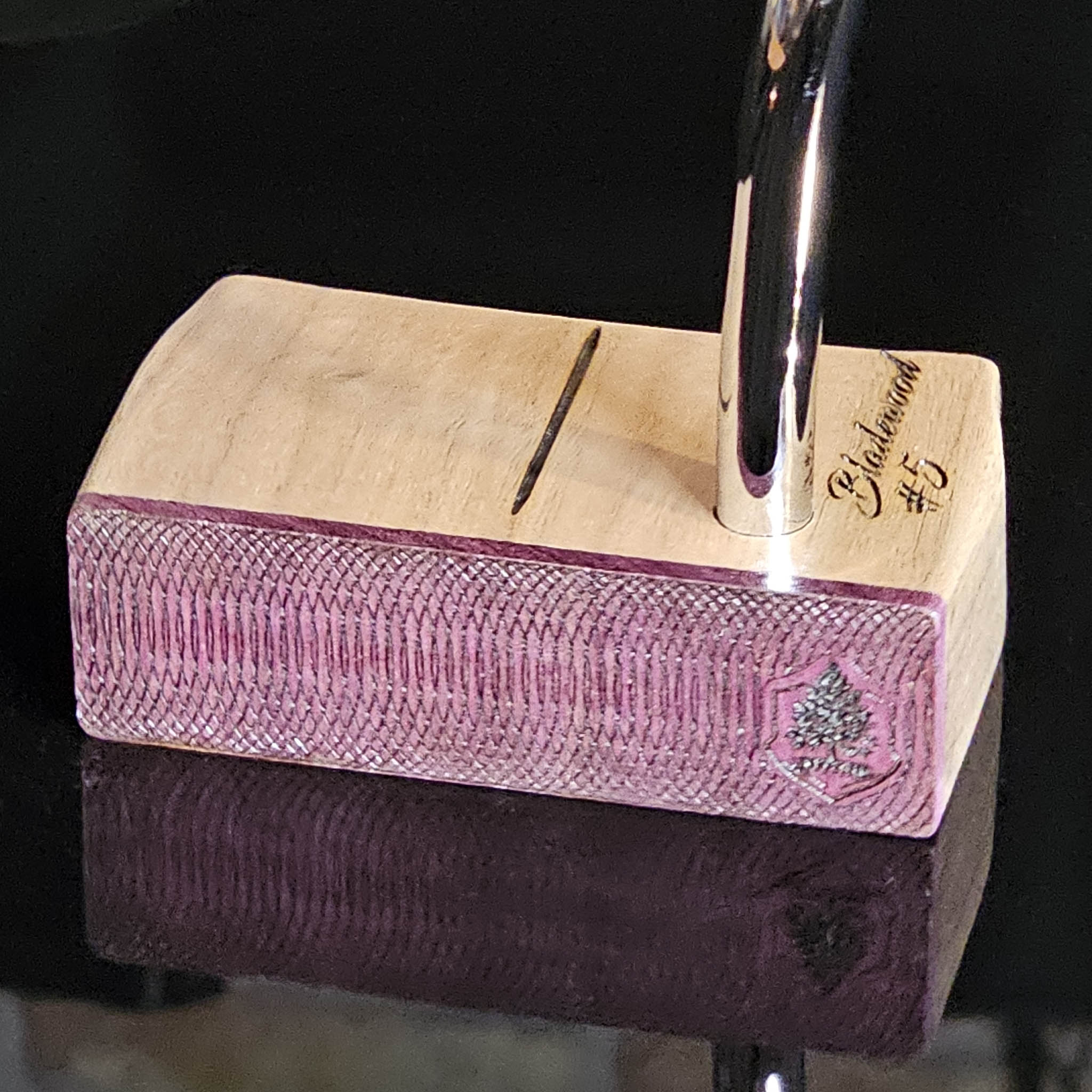 Walnut wood body putter with Purpleheart face.   Clean alignment line top view