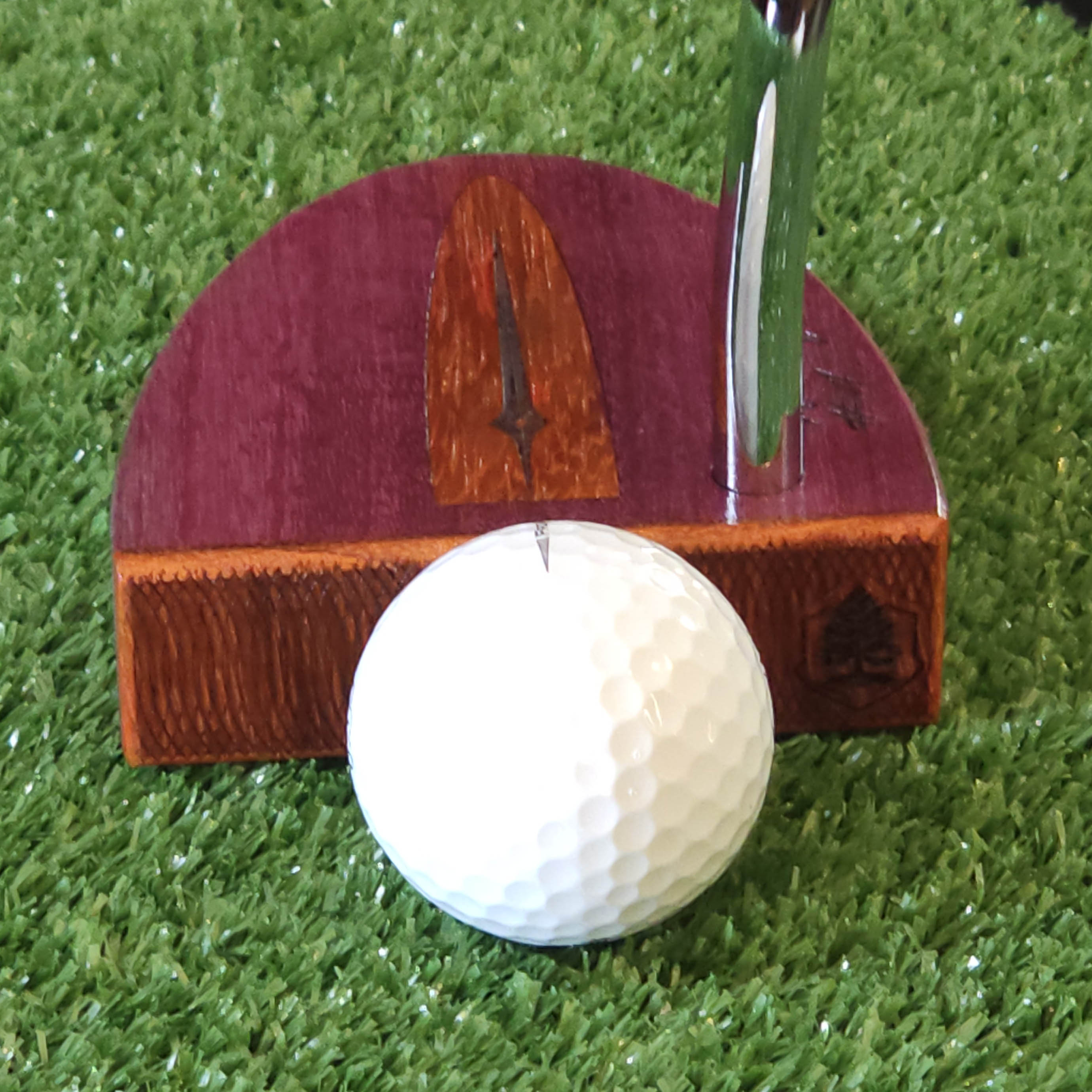 Purpleheart wood putter with Paduak wood inlay and faceplate