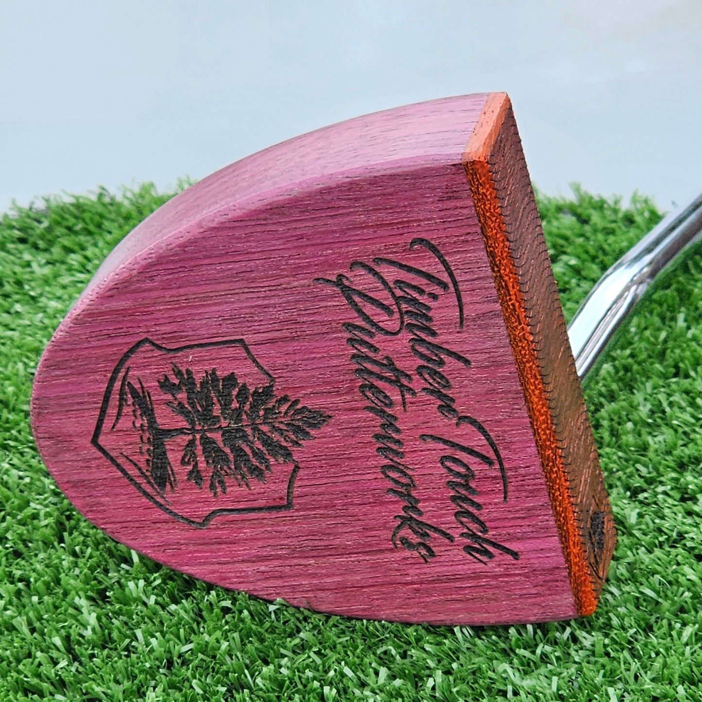 Purpleheart wood putter with Paduak wood inlay and faceplate