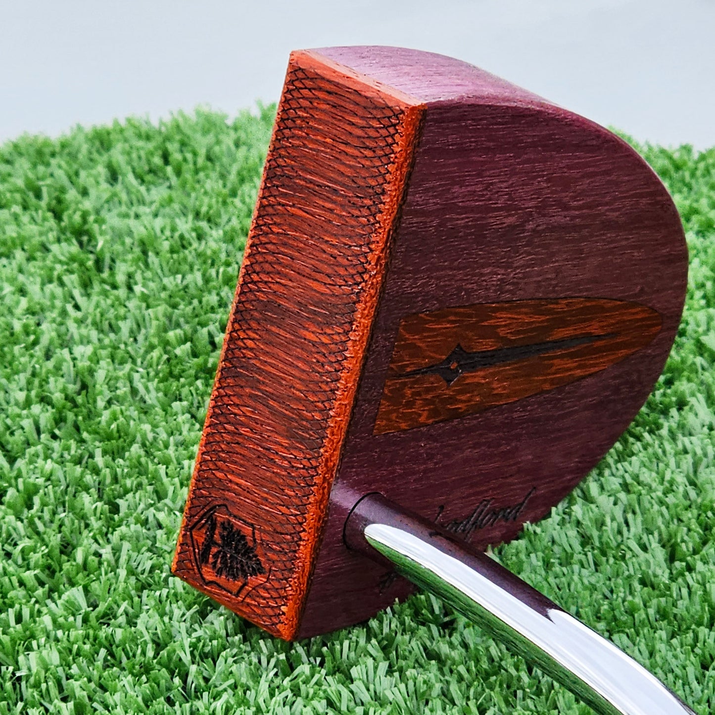 Purpleheart wood putter with Paduak wood inlay and faceplate