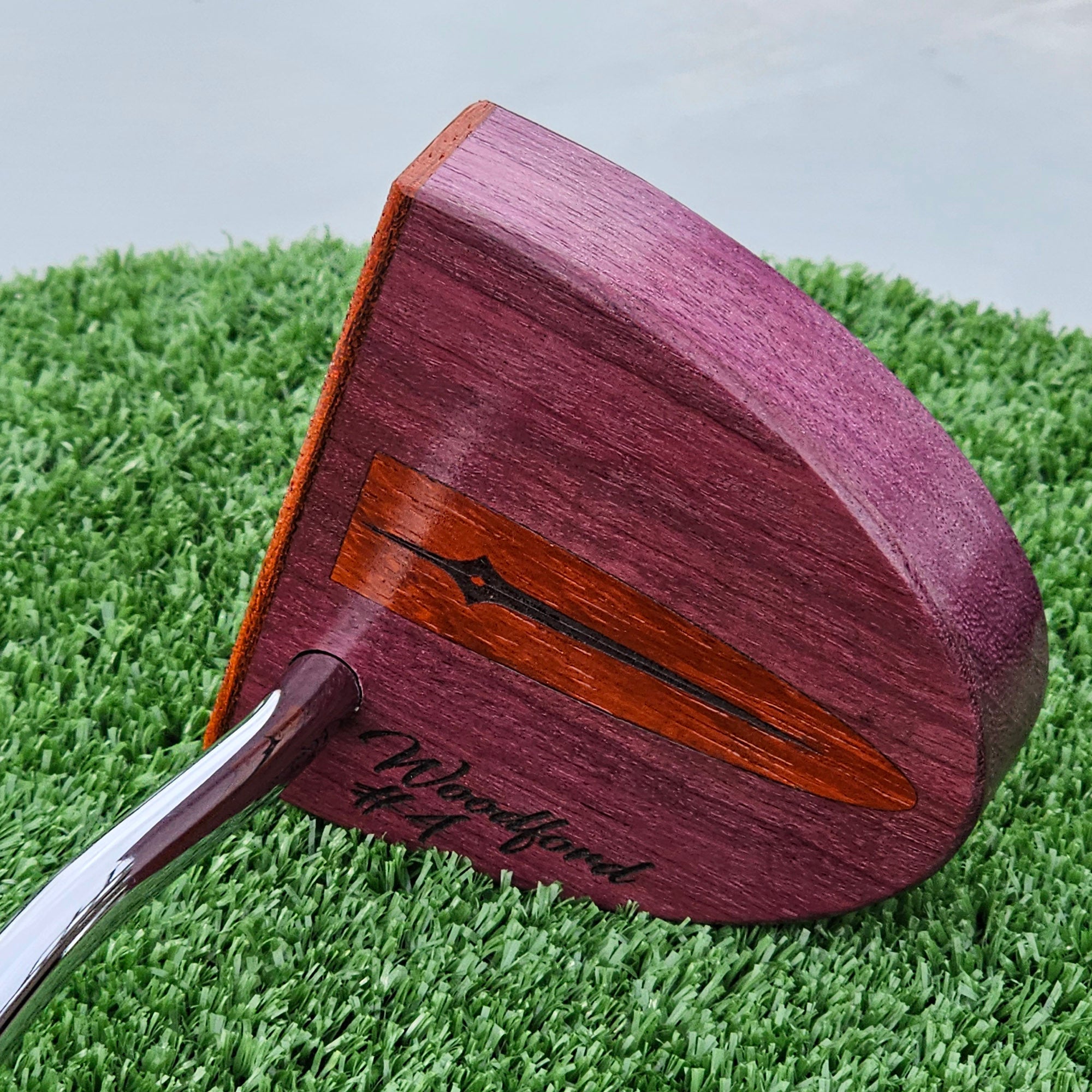 Purpleheart wood putter with Paduak wood inlay and faceplate