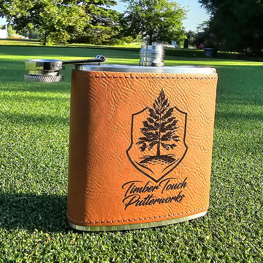 Six ounce hip flask with Timber Touch Putterworks logo on tan faux leather