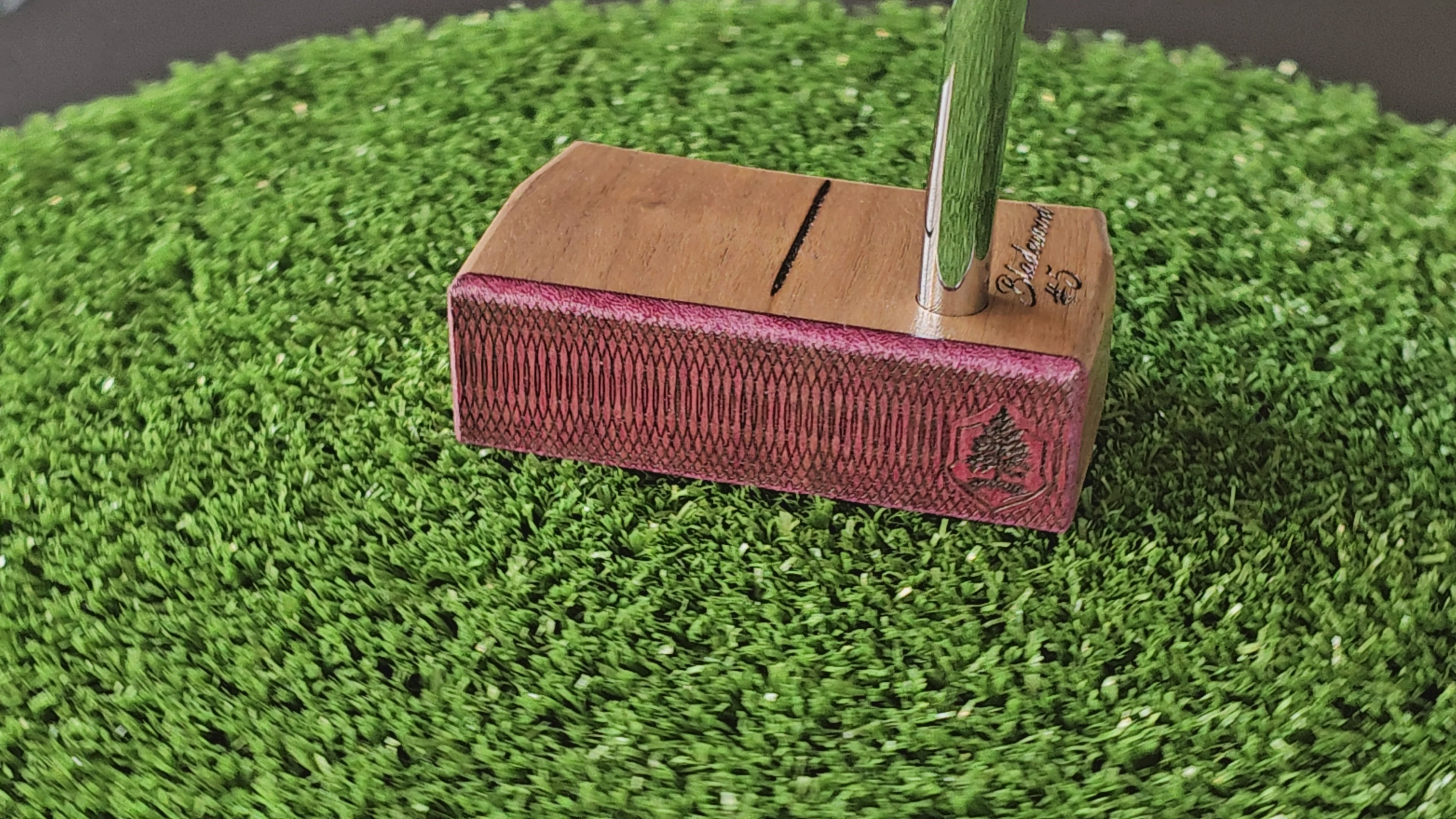 Walnut wood body putter with Purpleheart face.   Clean alignment line top view